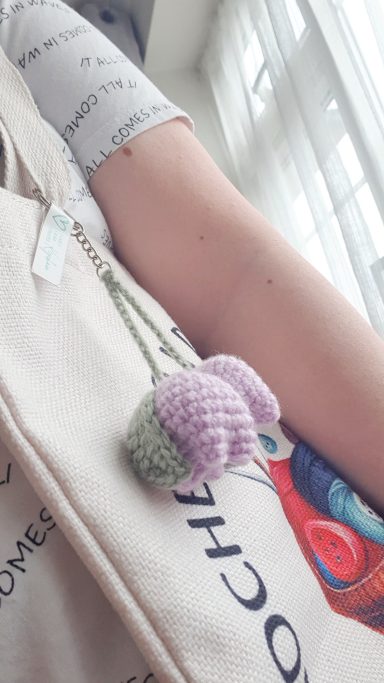a keyring crocheted in the shape of 2 tulips