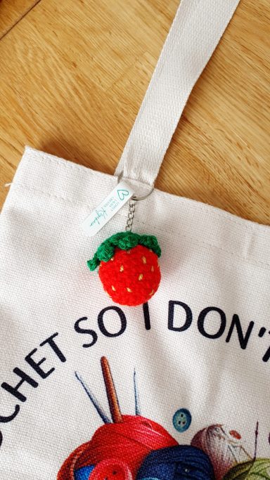 a keyring crocheted to look like a strawberry