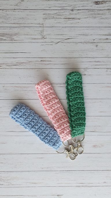 A wristlet (like a band) on a keyring in the colours blue, pink and green